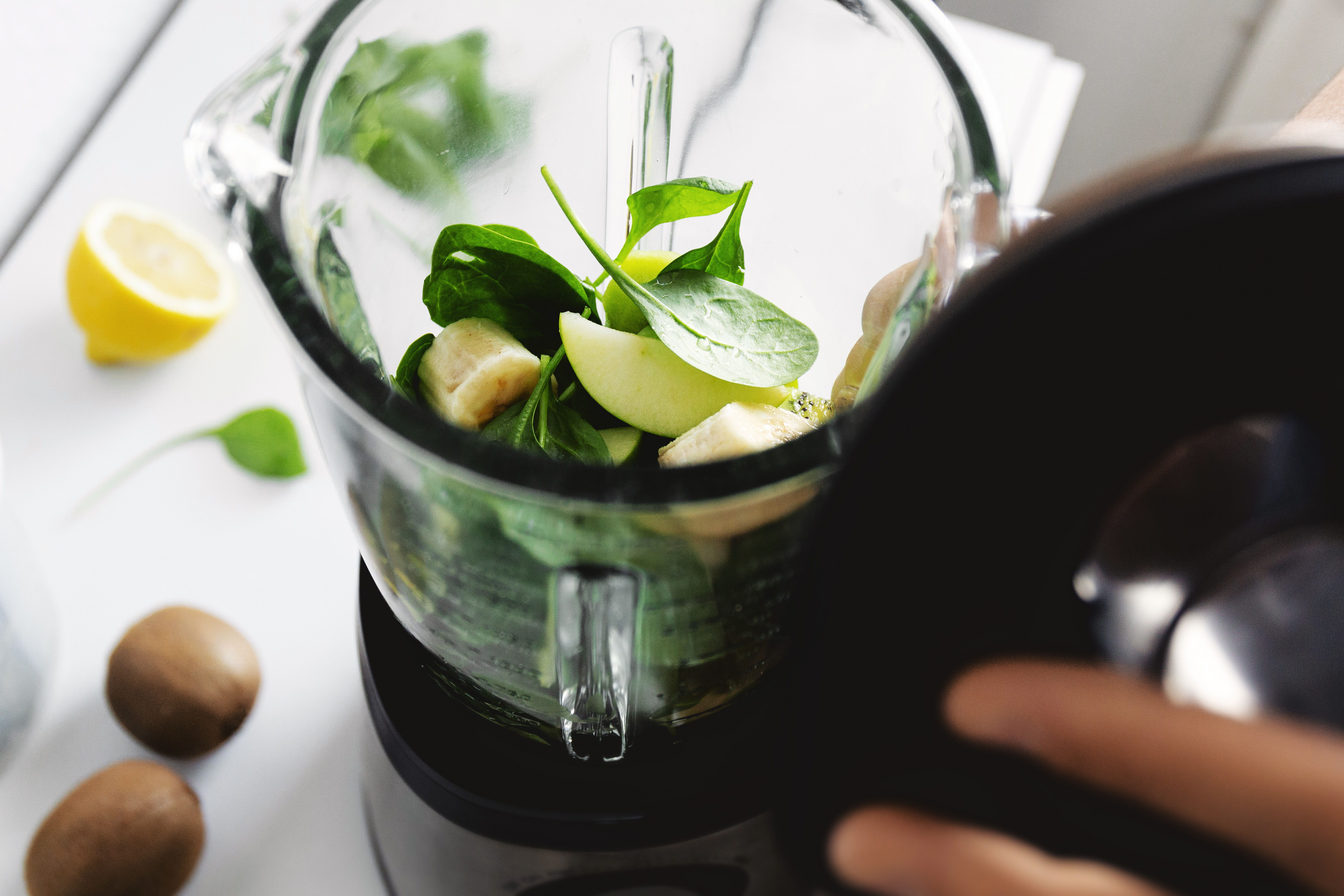 Man cooking smoothie in blender at home